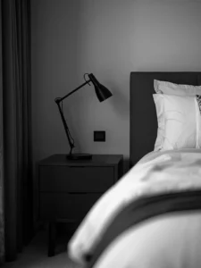 black metal lamp, white bedding