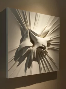 A close-up of a large square plaster relief art panel on a bedroom wall