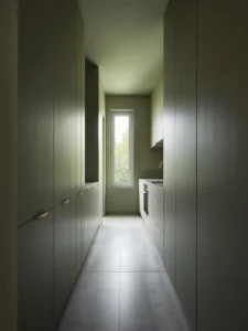 A narrow galley kitchen with seamless floor-to-ceiling