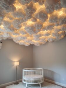A nursery ceiling transformed into a softly glowing cloudscape