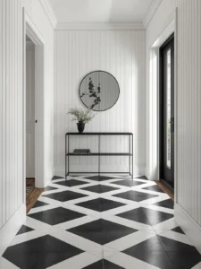 An entryway floor in bold oversized black and white encaustic cement tile