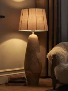 Scandinavian living room focused on a large hand-thrown ceramic floor lamp