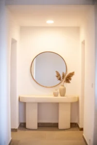 bright hallway with a curved-front white plaster console