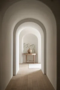 bright white hallway with a smooth plaster arched doorway