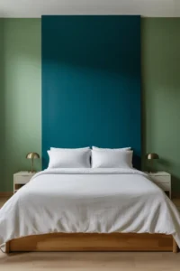 deep teal accent wall behind queen bed