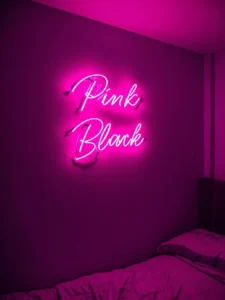 dorm room with pink neon sign