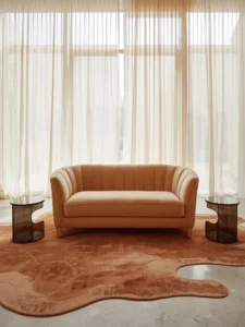 living room centered around a crescent-shaped bouclé sofa