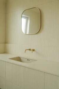 vanity wall covered in vertical fluted MDF wall panels