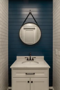 vertical shiplap wall painted deep navy blue behind white undermount sink vanity