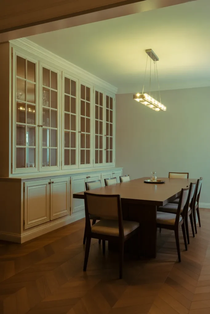 a formal dining room with a floor-to-ceiling built-in painted