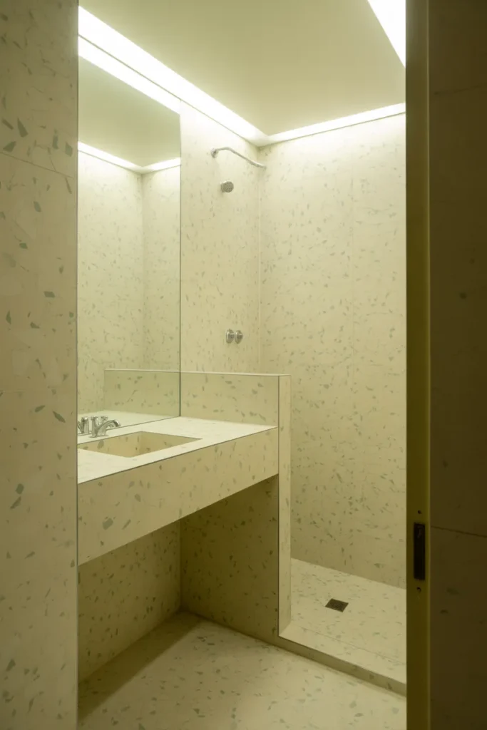 a small bathroom fully clad in cream terrazzo