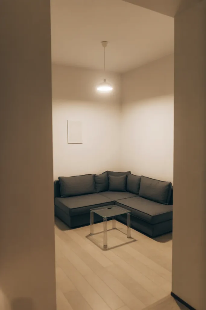 a small living room with a compact charcoal L-shaped sofa