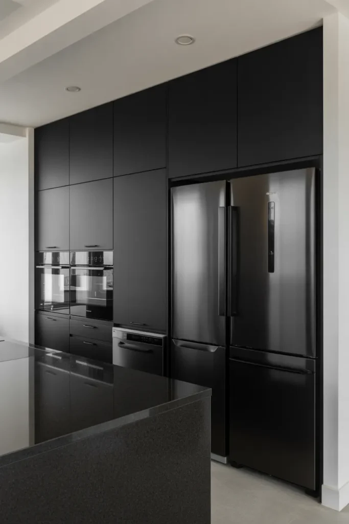 All-Black Kitchen With Integrated Appliances and Invisible Handles