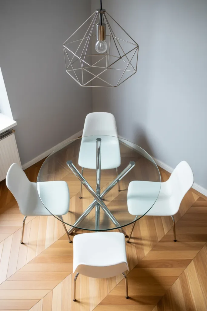 The Glass-Top Round Table That Visually Expands a Small Dining Area